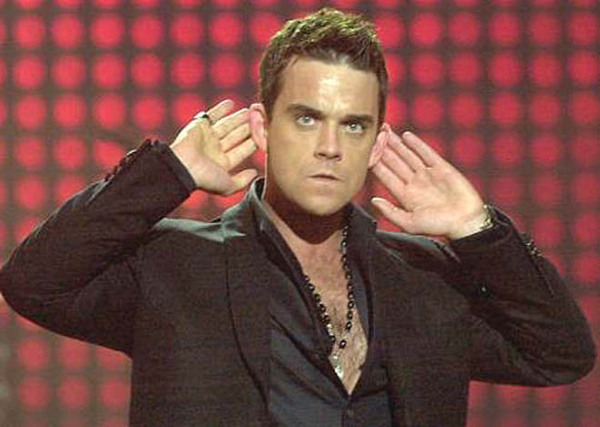 Confident Robbie Williams poses naked on his birthday to reveal impressive six pack