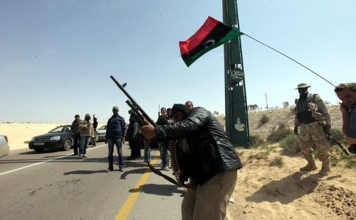 Libyans flee pro-Qaddafi town ahead of assault; new leaders seek UN representation