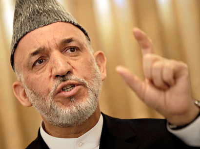 Afghanistan's Karzai heads to Qatar to discuss peace with Taliban