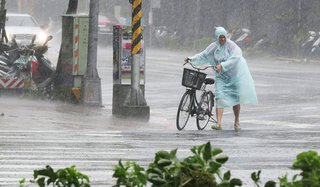 Japan rescuers wade in muddy waters to find typhoon survivors