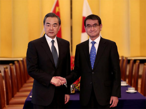 Japan and China's foreign ministers pledge to pursue improved ties
