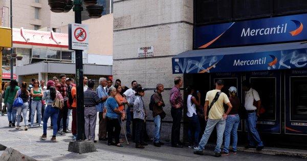 Venezuelans rush to shop, fill tanks before monetary overhaul