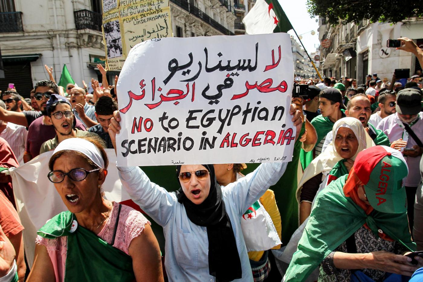 Algerian protesters march in last Friday rally before election
