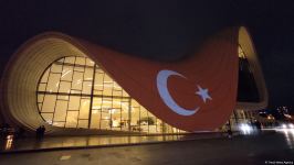 Building of Baku's Heydar Aliyev Center painted in colors of Turkish flag