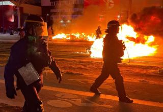 Paris police, protesters clash for third night over Macron's pension reform